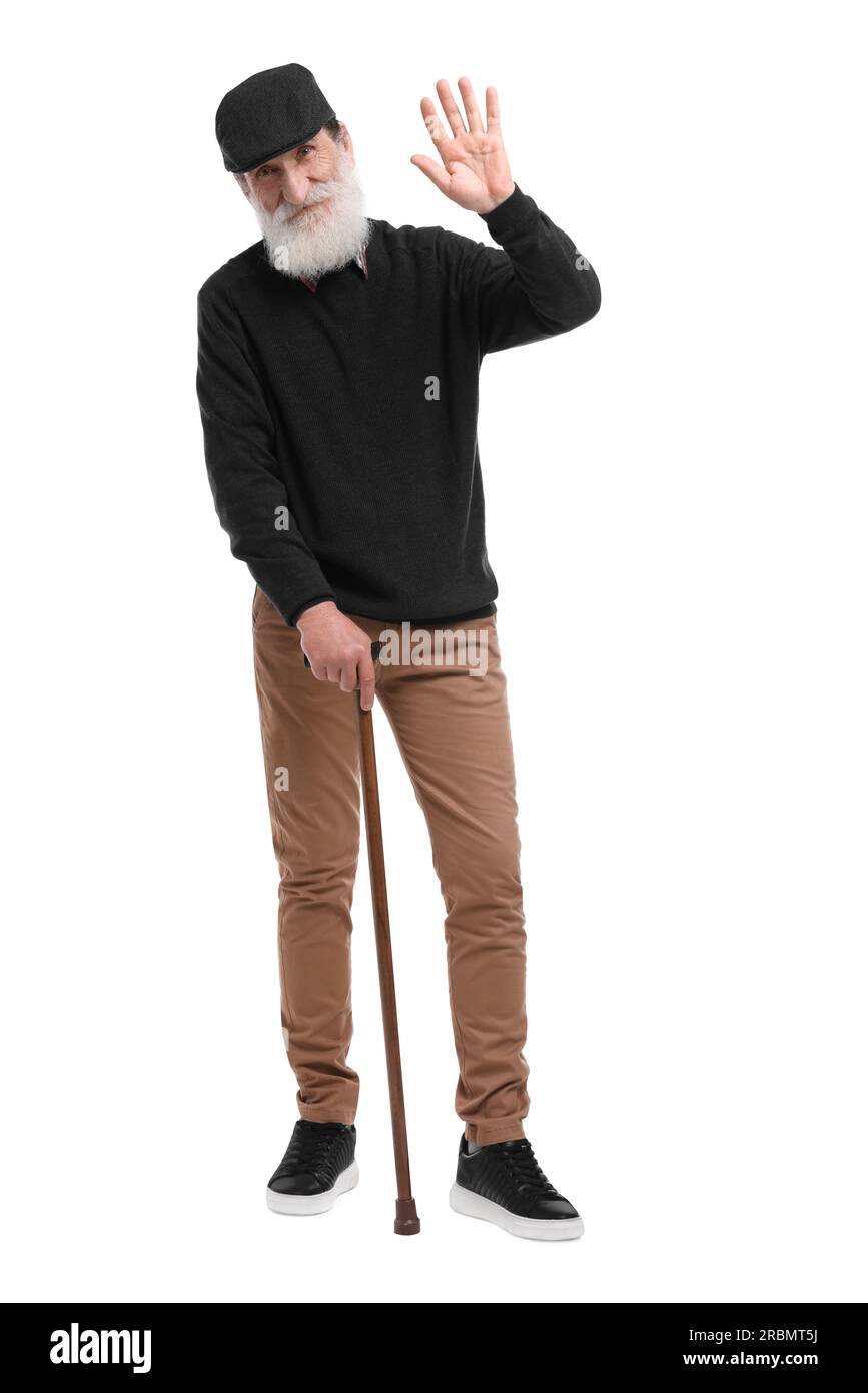 Senior man with walking cane waving on white background Stock Photo - Alamy