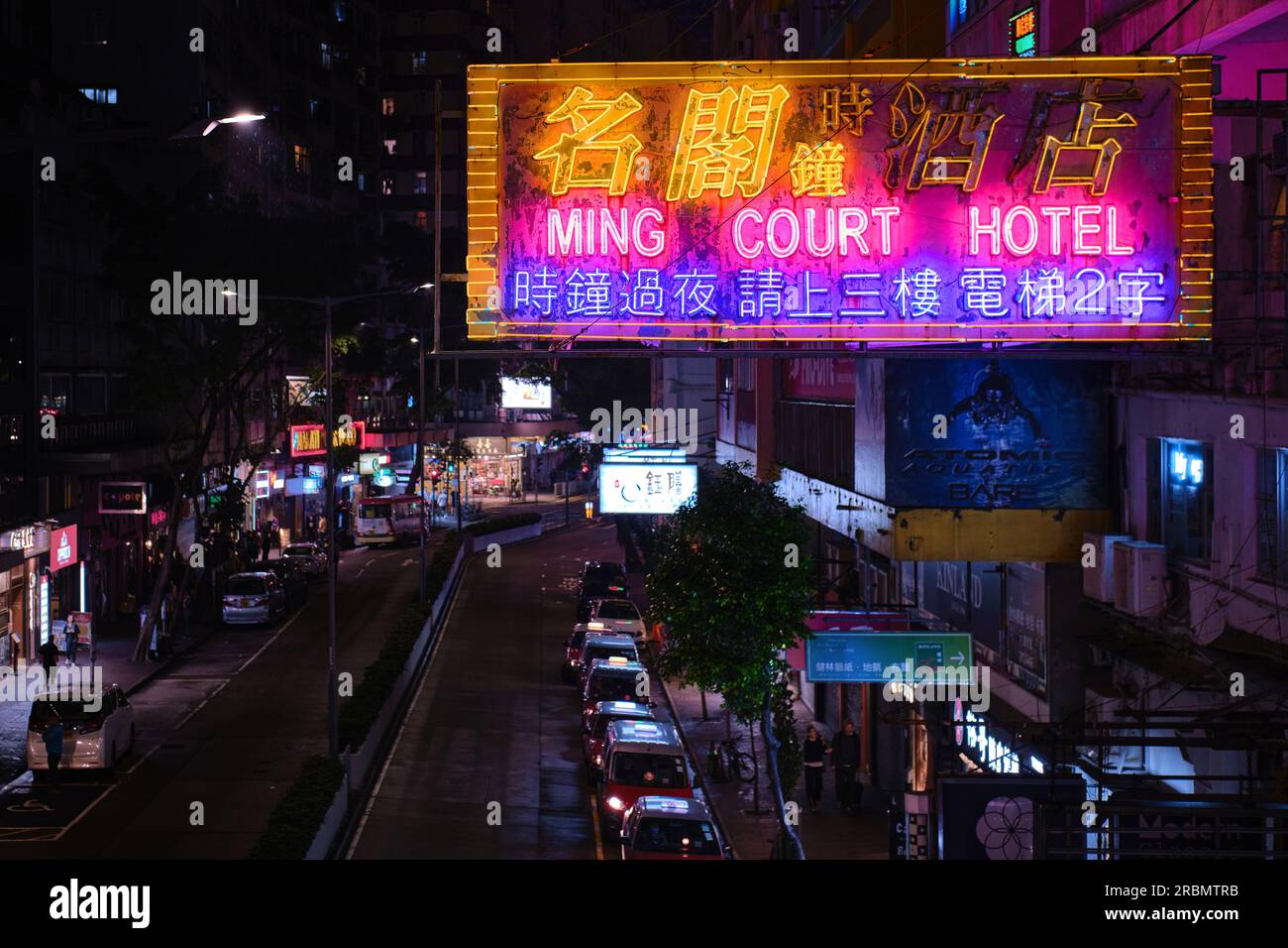 Hong Kong, China - April 28 2023: Colorful Neon light Sign of a hotel and red taxi line at night on Lockhart Road Stock Photo