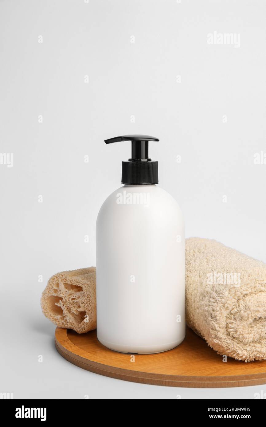 https://c8.alamy.com/comp/2RBMWH9/bottle-with-cosmetic-product-rolled-towel-and-loofah-sponge-on-white-background-2RBMWH9.jpg