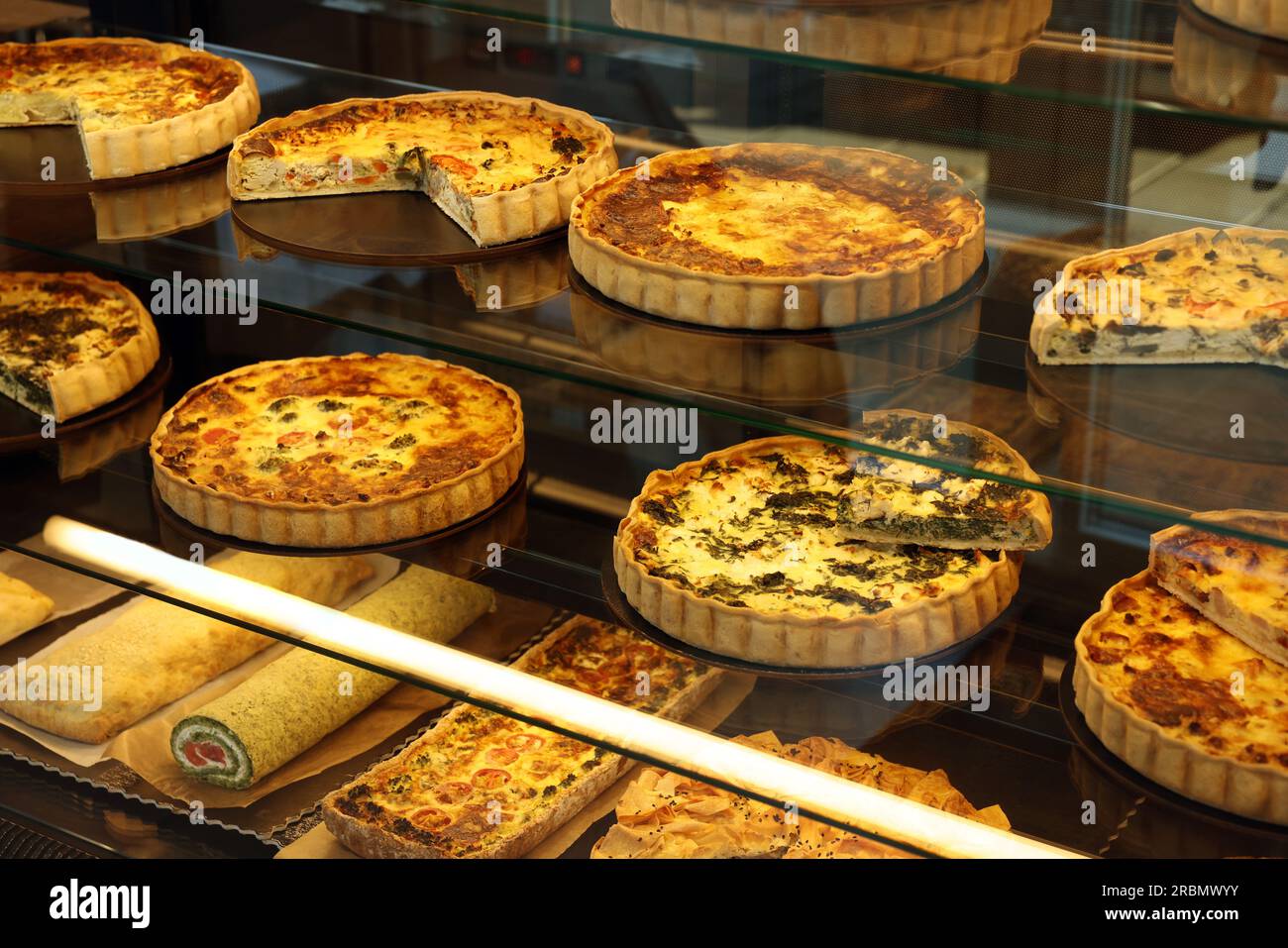 Different delicious quiches on counter in bakery shop Stock Photo Alamy