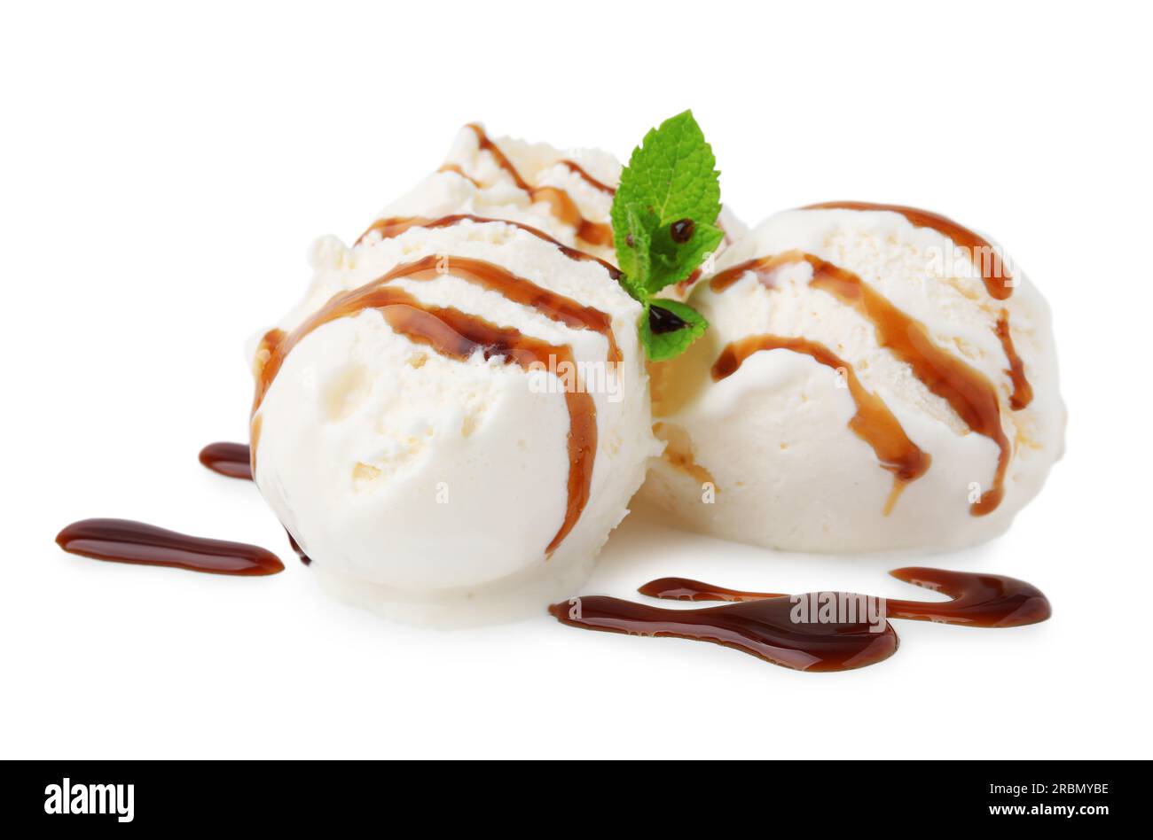 Scoops of ice cream with caramel sauce and mint isolated on white Stock ...