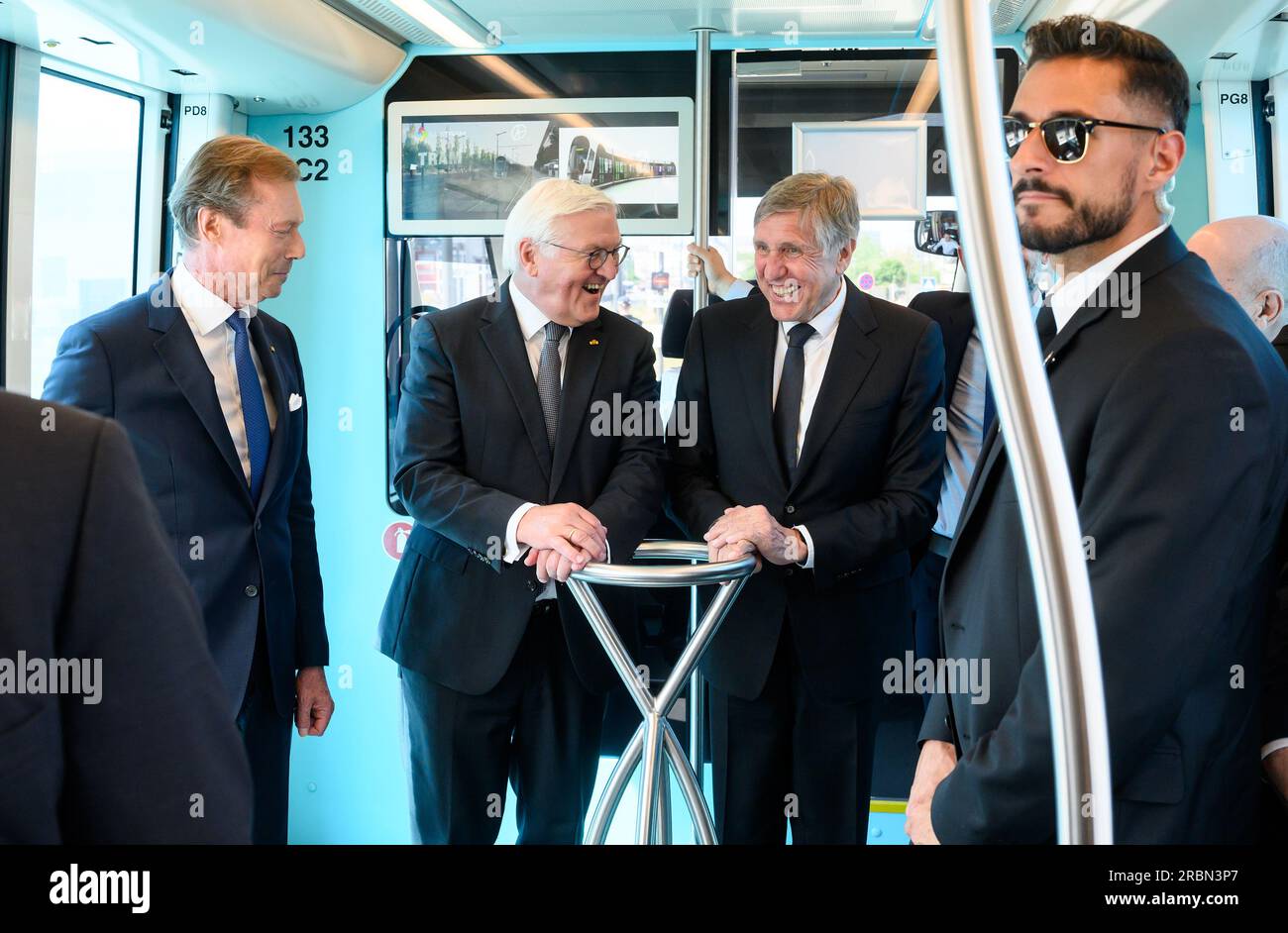 10 July 2023, Luxembourg, Luxemburg: German President Frank-Walter Steinmeier (m) rides a streetcar through Luxembourg City with Grand Duke Henri of Luxembourg (l) and Francois Bausch, Deputy Prime Minister and Minister for Mobility. President Steinmeier and his wife are in Luxembourg for a two-day official visit. Photo: Bernd von Jutrczenka/dpa Stock Photo