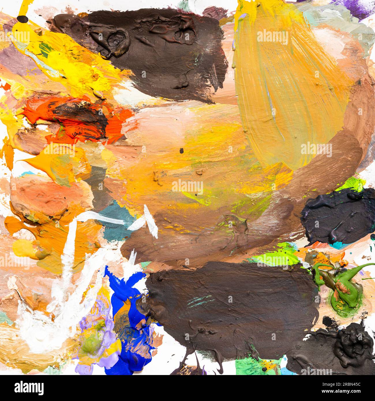 dried multicolored tempera paints on art palette on white paper Stock