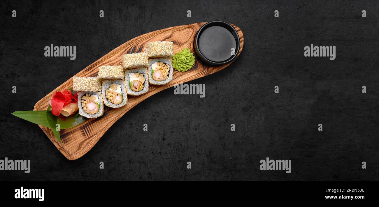 Classic sushi roll with seafood, soy sauce, wasabi and ginger. dark background, horizontal banner Stock Photo