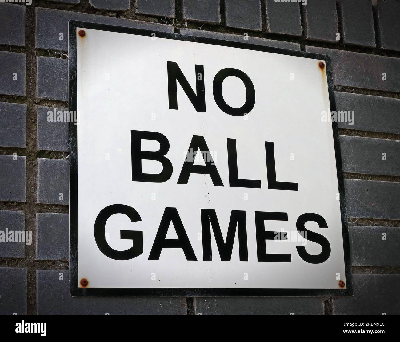 Classic “No Ball Games” sign mounted on a brick wall on a council housing estate in England, Scotland, Wales, Ireland Stock Photo