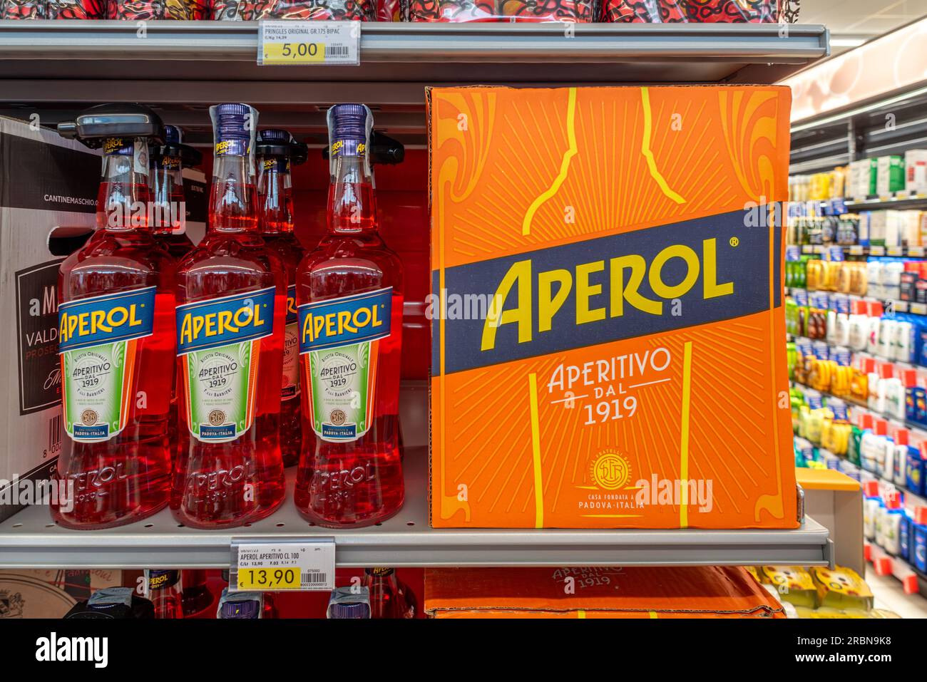 Italy - July 10, 2023: Aperol bottles and box on shelf for sale in Italian supermarket. Aperol Italian aperitif liqueur for making spritz cocktails ma Stock Photo