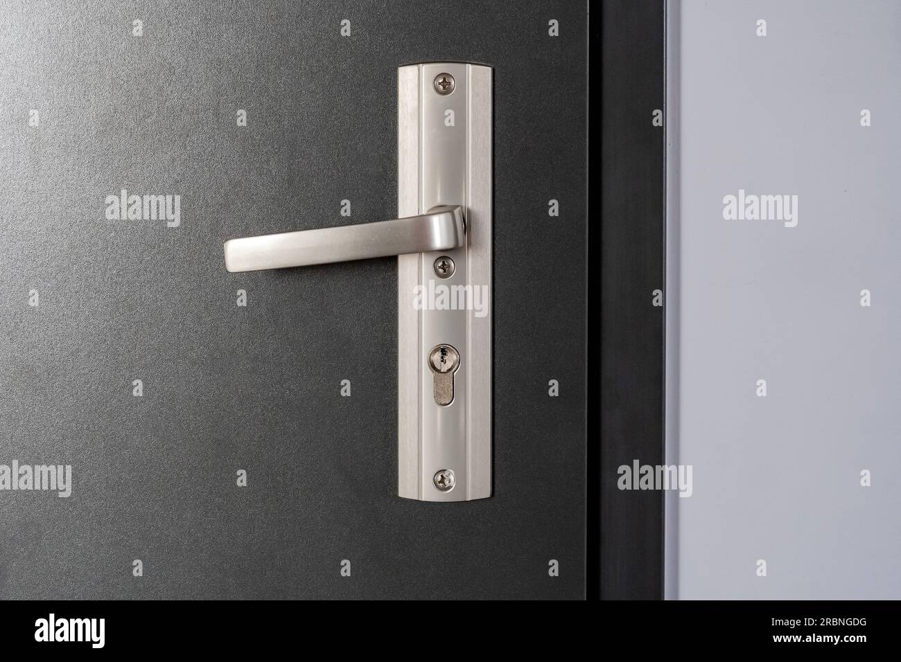 Simple modern metal door handle on a brand new apartment door, front ...