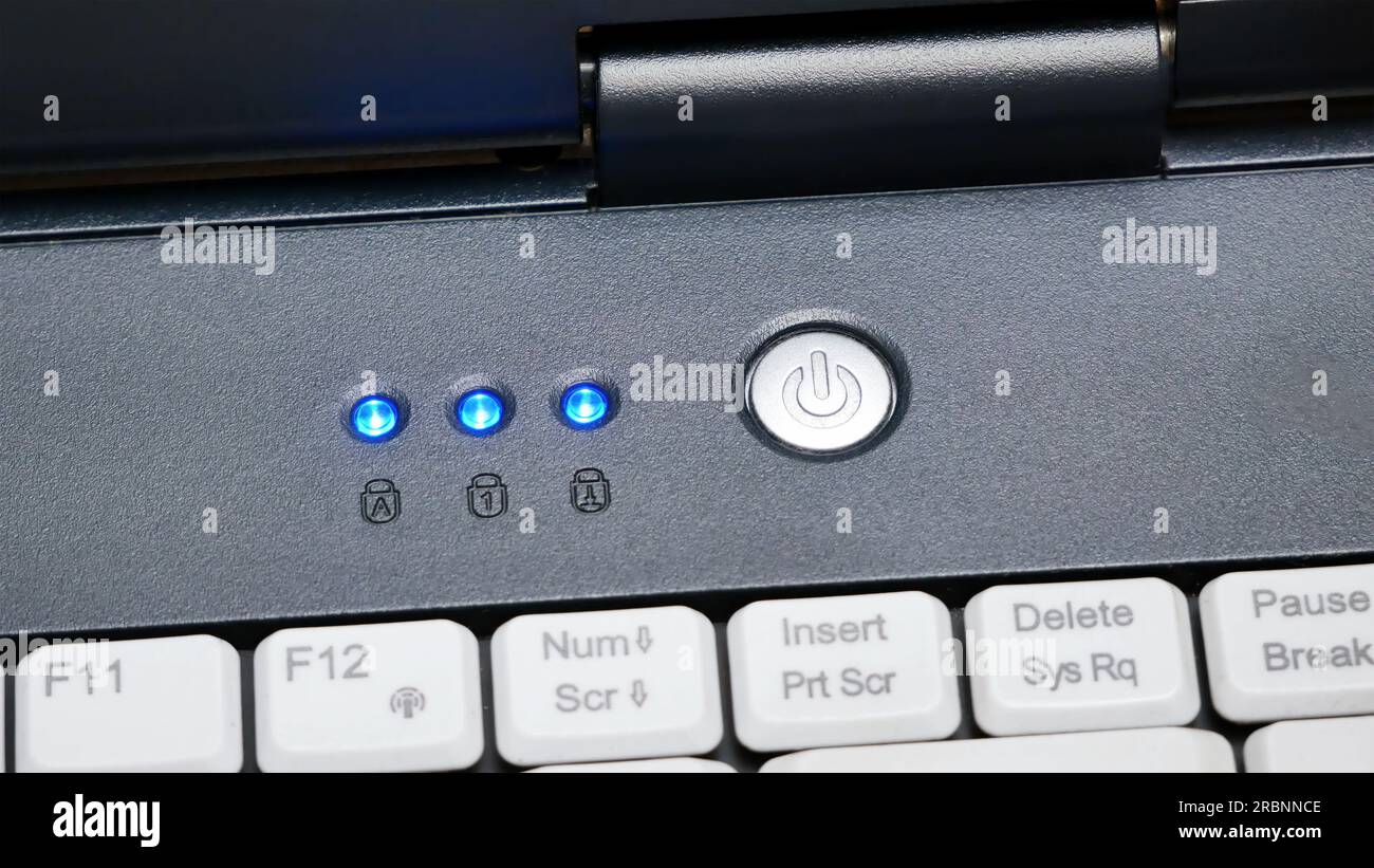 Laptop power button up close, powering on, turning on an electronic device, computer startup