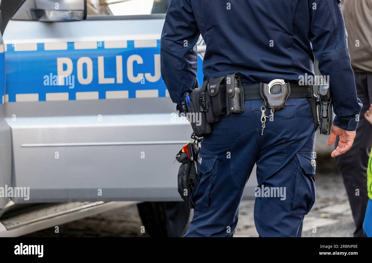 Polish police vehicle and a policeman equipment, gun, handcuffs utility
