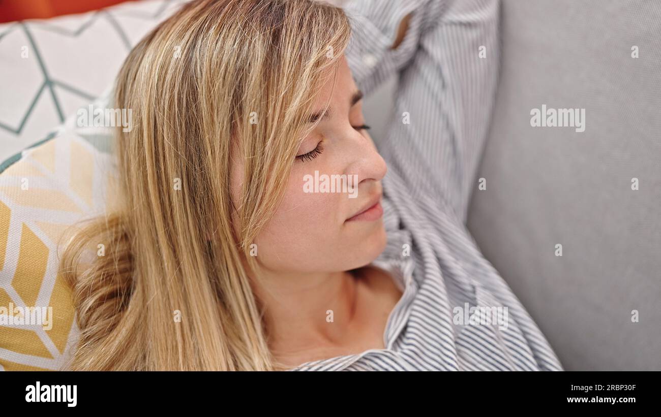 Blonde woman lying on sofa hi-res stock photography and images - Alamy