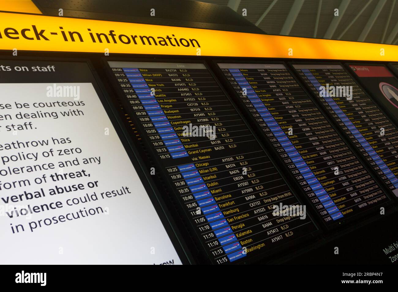 A flights arrival and check-in board in an airport. Panel also shows notice on staff Stock Photo