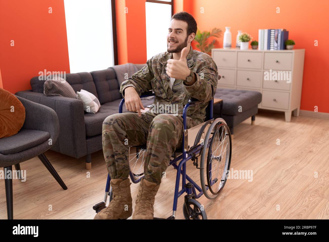 Young hispanic soldier man injured sitting on wheelchair smiling happy ...
