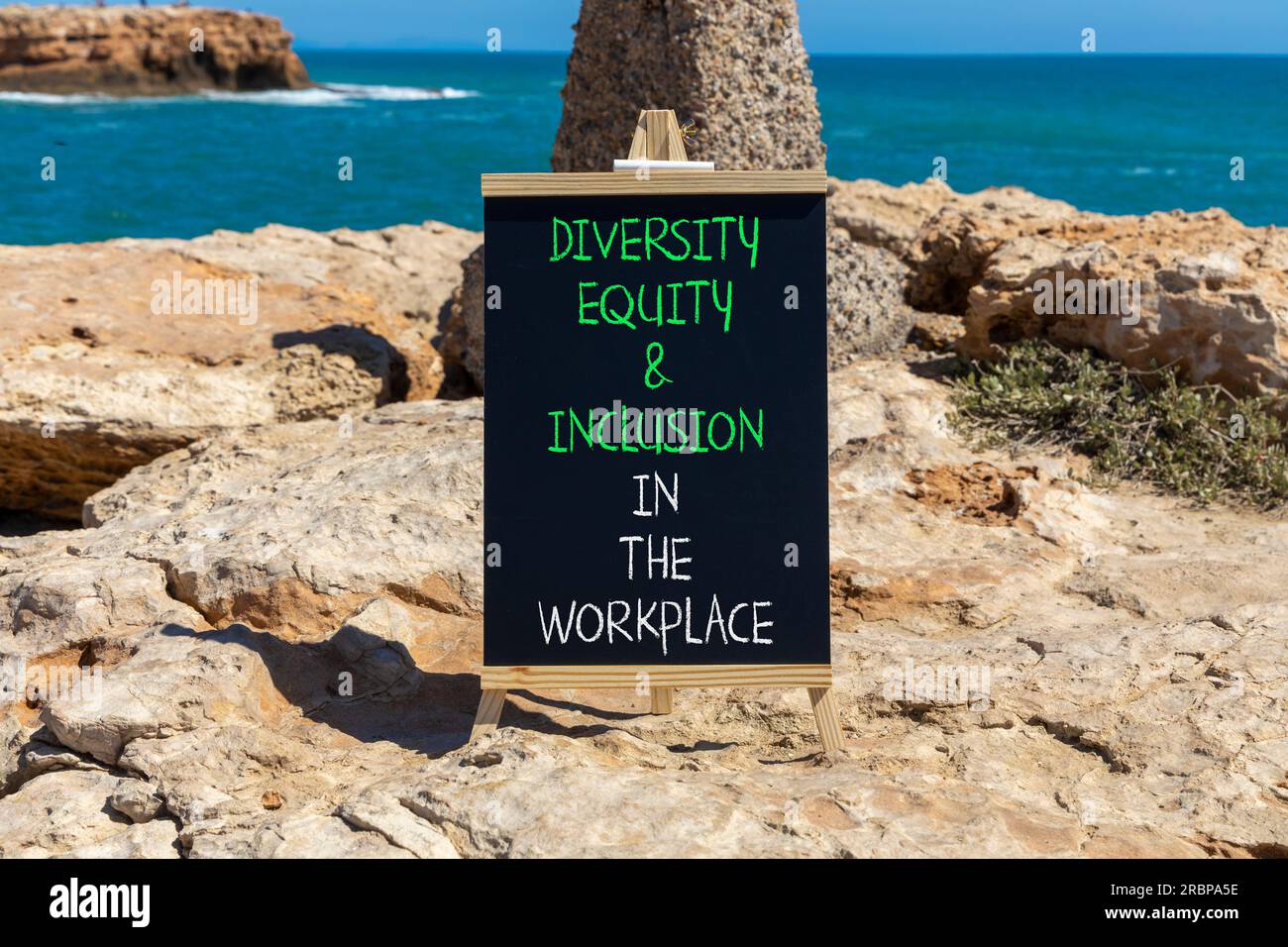 Diversity equity inclusion symbol. Concept words Diversity Equity and Inclusion in the workplace on blackboard on a beautiful stone background. Divers Stock Photo