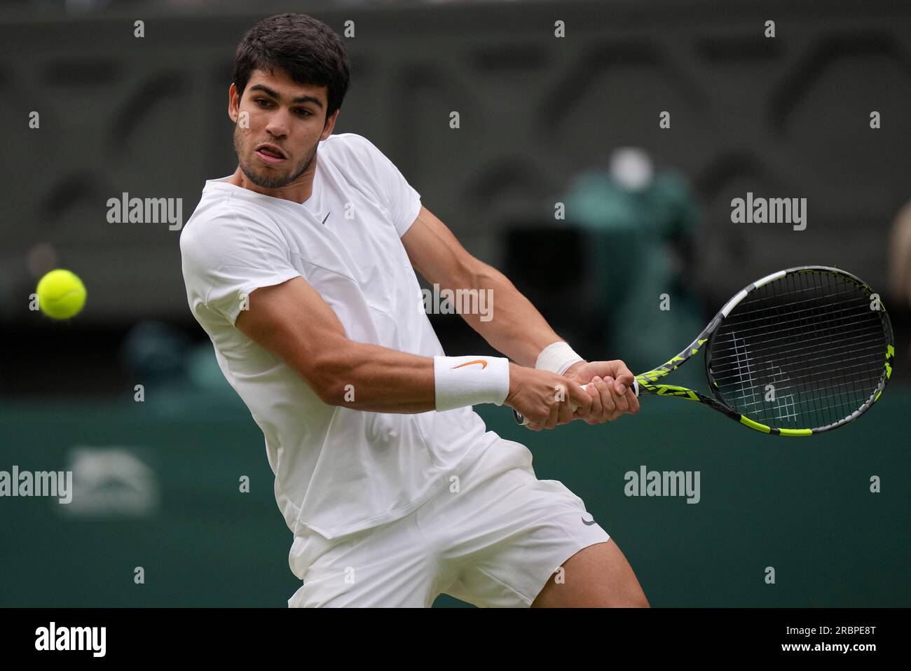 Spains Carlos Alcaraz returns to Italys Matteo Berrettini in a mens singles match on day eight of the Wimbledon tennis championships in London, Monday, July 10, 2023