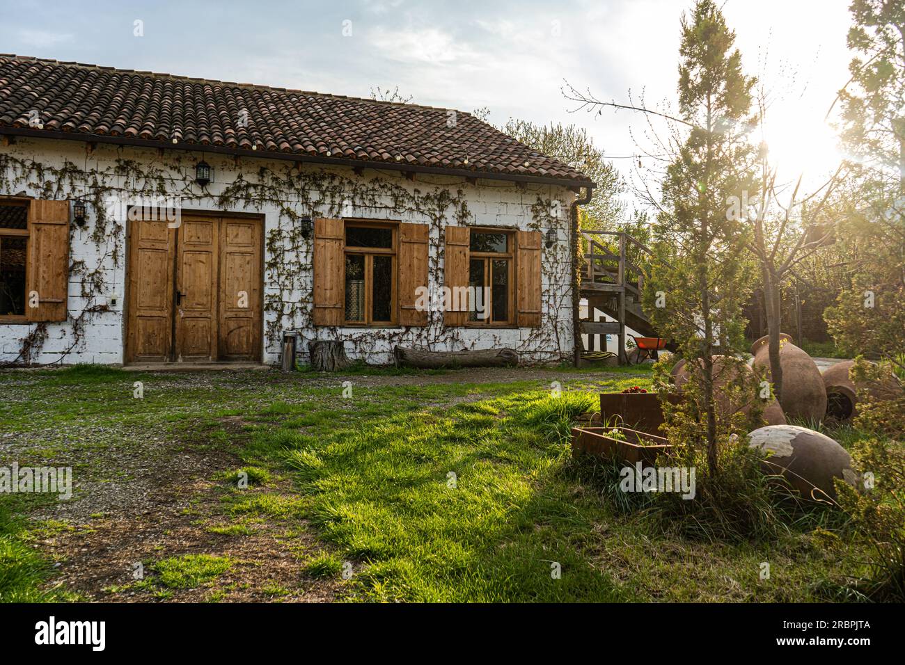Winery building with white stone walls covered with grape and shingles