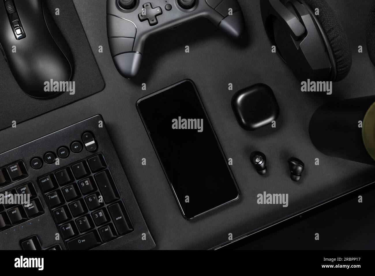 Various modern devices on black desk Stock Photo
