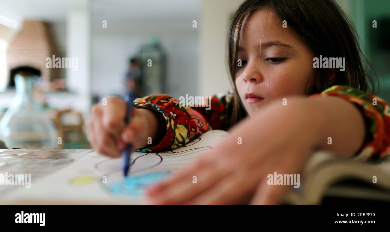 Little girl drawing on paper child draws with color crayon Stock Photo ...