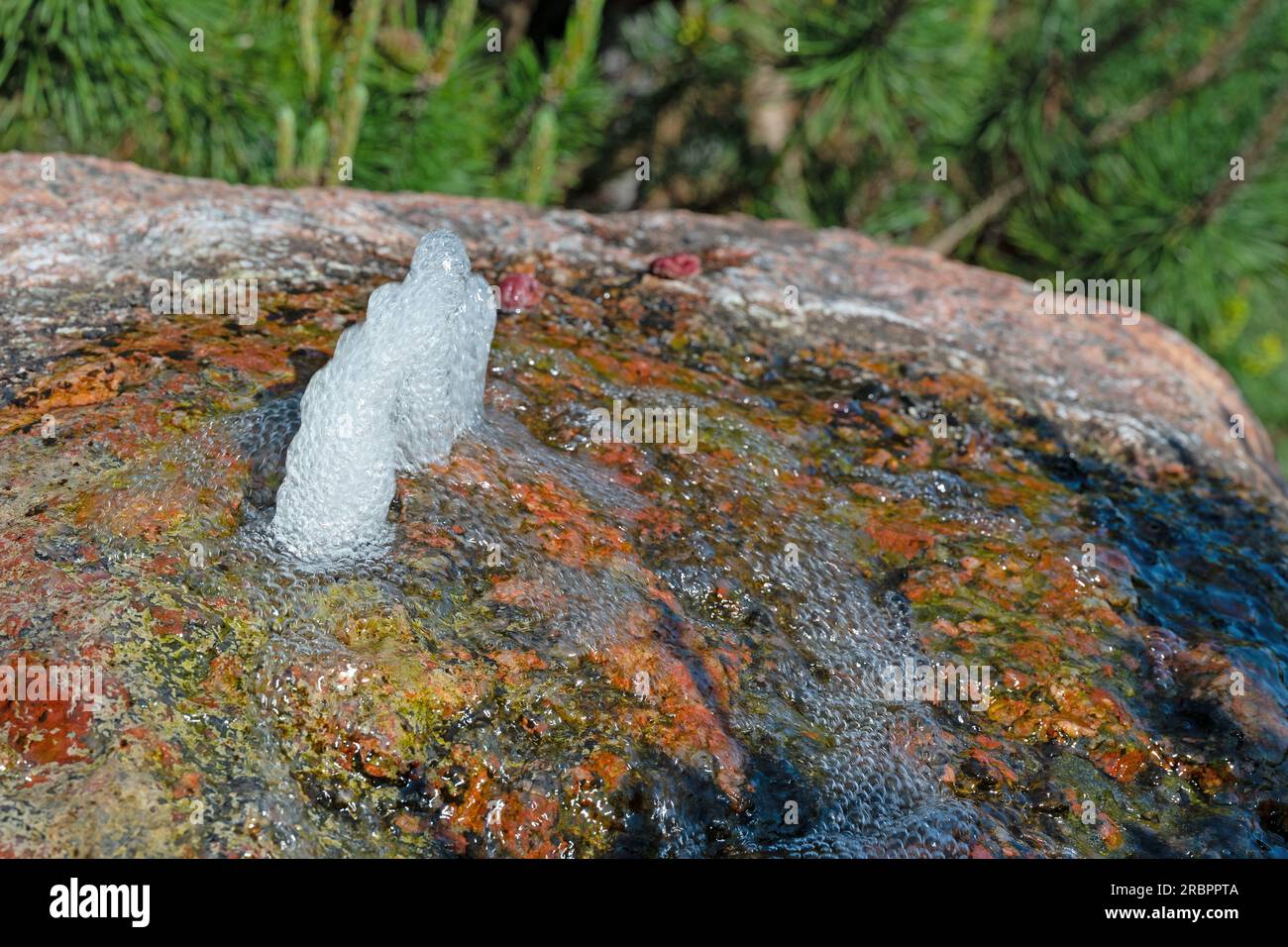 Small water fountain on a colorful stone Stock Photo Alamy