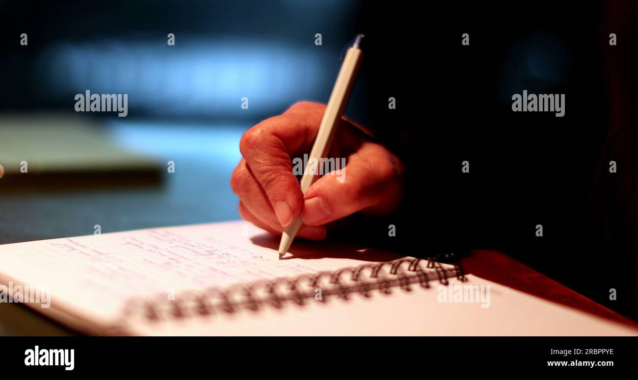 Hand holding pen writing notes closeup person taking notes Stock Photo Alamy