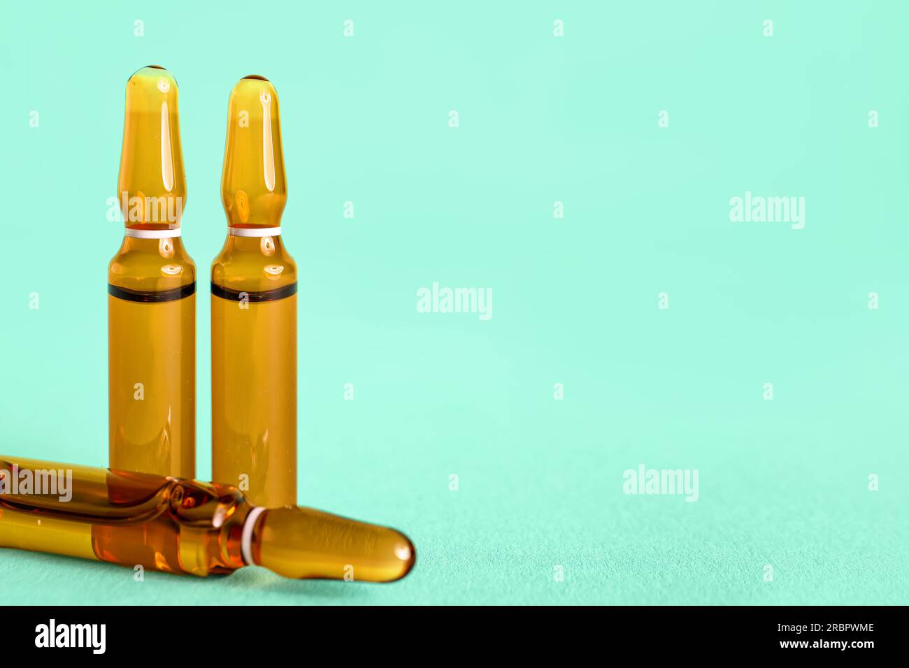 Glass ampules on turquoise background Stock Photo Alamy