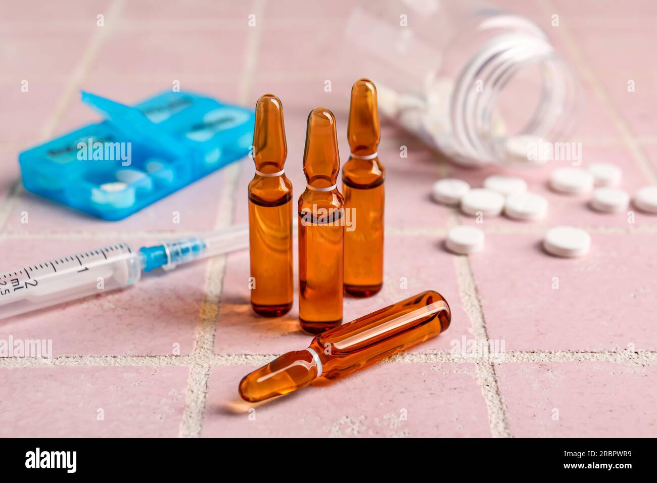 Medical ampules on pink tile background Stock Photo Alamy