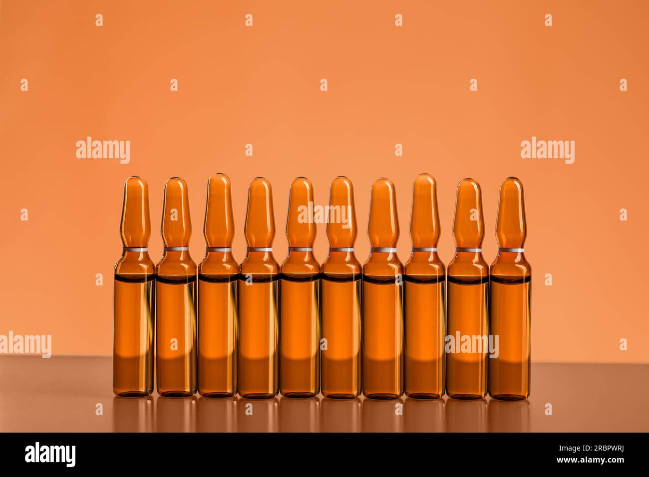 Medical ampules on orange background Stock Photo Alamy