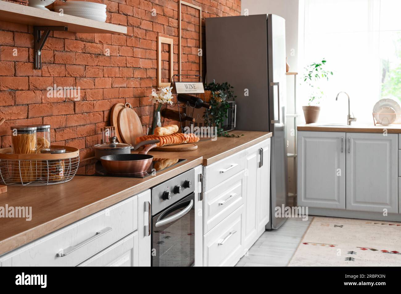 Interior of kitchen with stylish fridge, counters and utensils Stock ...