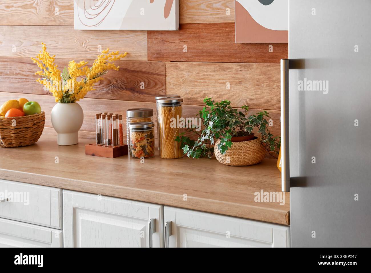 Interior of kitchen with stylish fridge, counters and houseplant ...