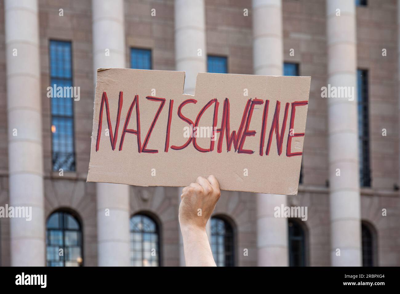 Nazischweine. A cardboard sign at demonstration against far-right minister Vilhelm Junnila in front of Parliament House in Helsinki, Finland. Stock Photo