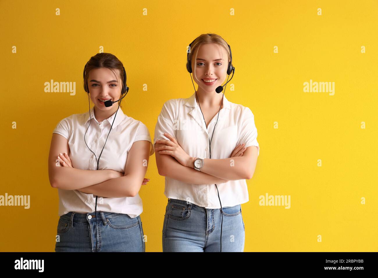 Female technical support agents on yellow background Stock Photo - Alamy