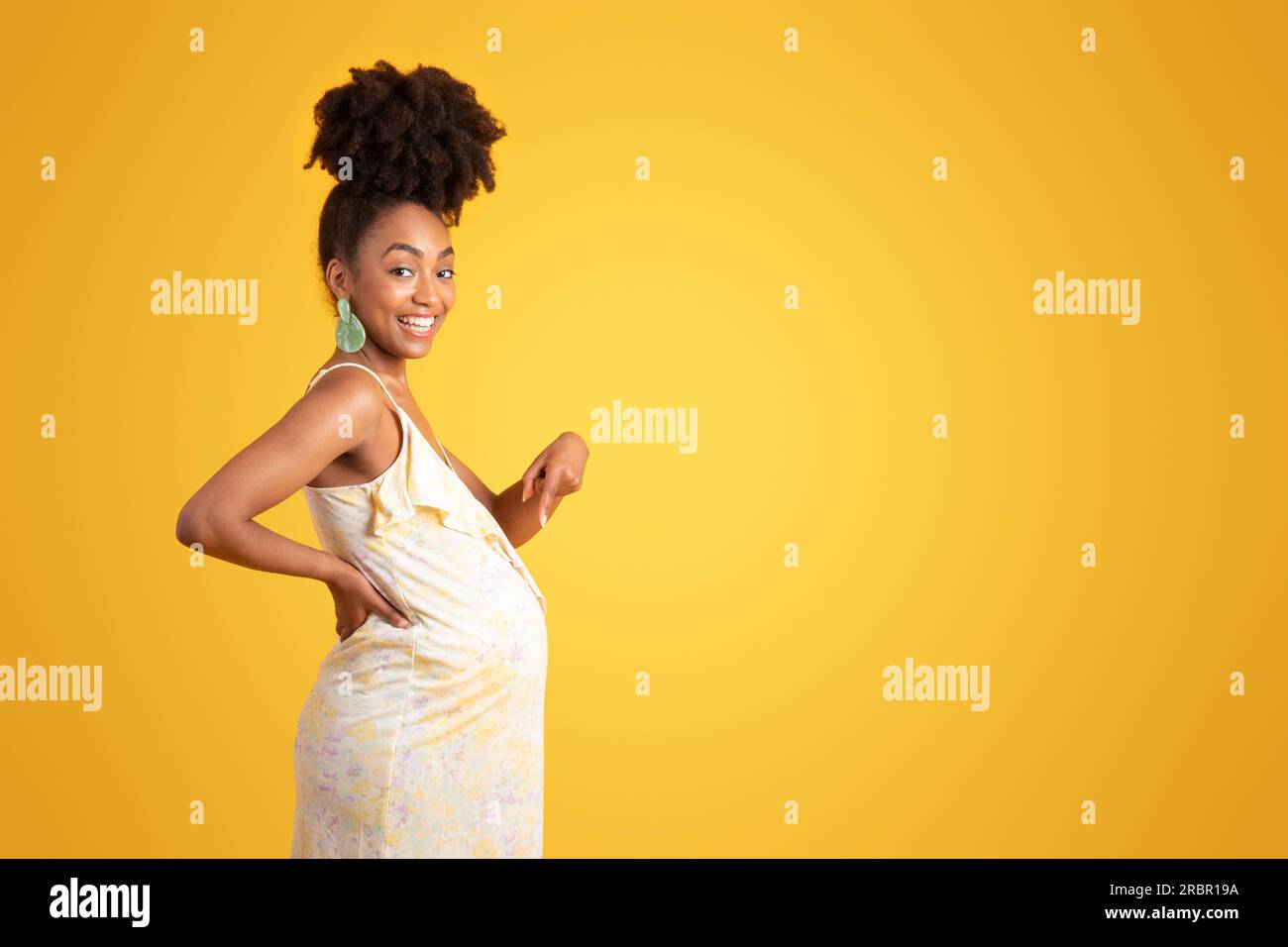 Cheerful proud millennial african american lady pointing finger at big ...