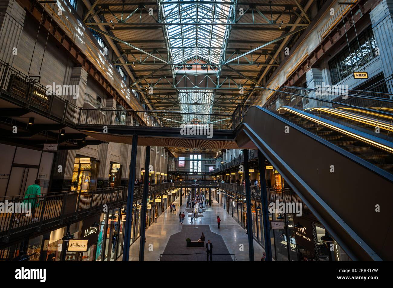 Battersea, London, UK: Battersea Power Station now redeveloped as a shopping and leisure destination. Interior of Turbine Hall A with escalator. Stock Photo