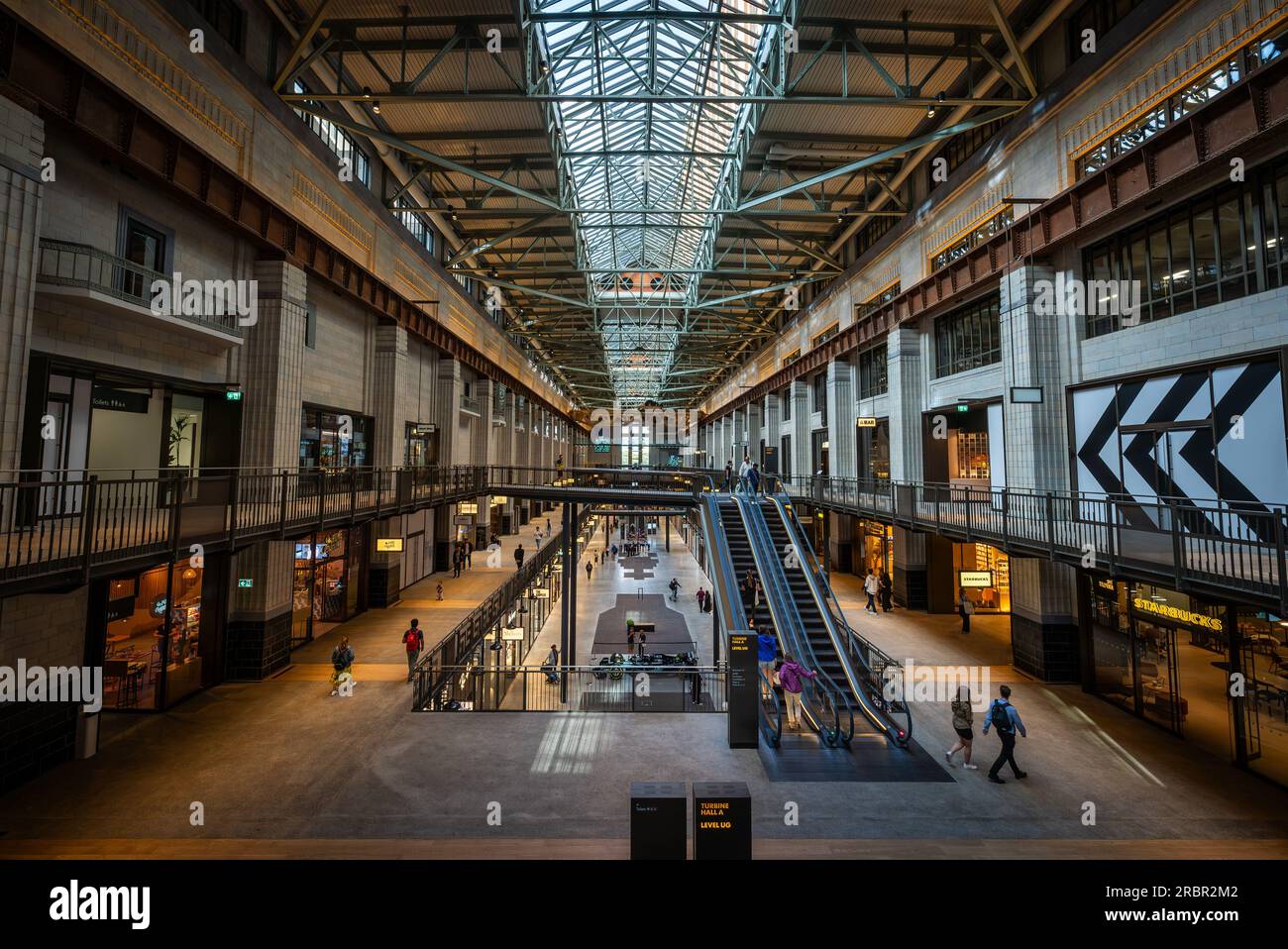 Battersea, London, UK: Battersea Power Station now redeveloped as a shopping and leisure destination. Interior of Turbine Hall A with escalator Stock Photo