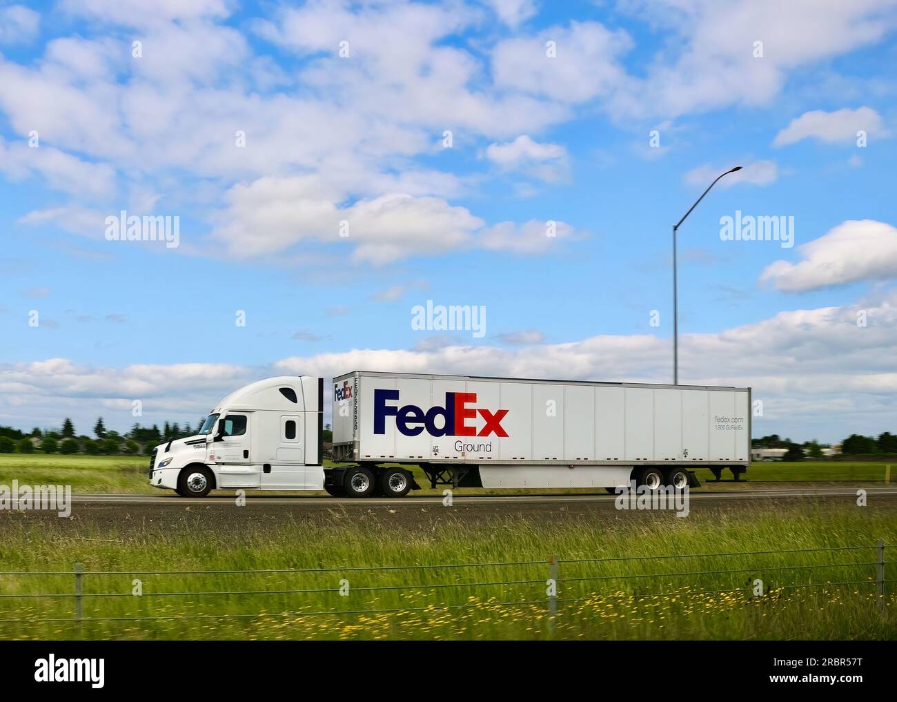 FedEx Ground Shipping low-cost package delivery truck driving south on Interstate 5 Oregon USA Stock Photo