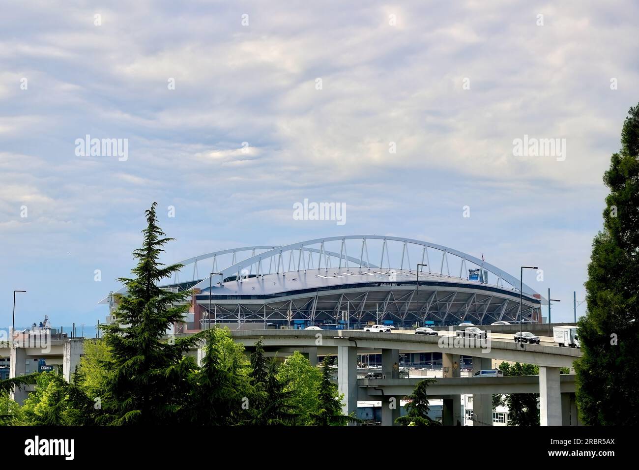 View from inside a car driving north on the I-5 of the Lumen Field stadium in the distance Seattle Washington State USA Stock Photo