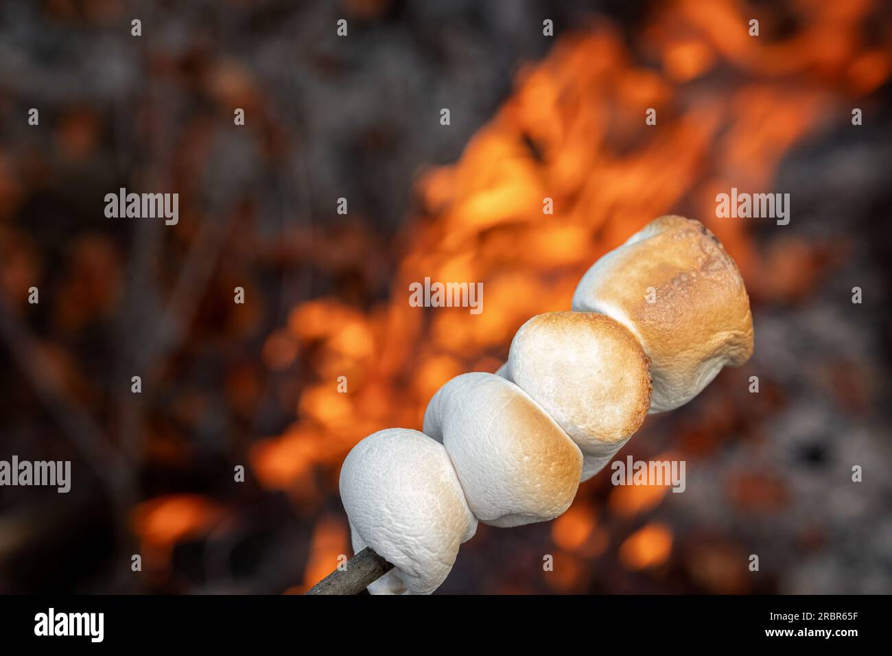 Marshmallow cooked on the fire. Marshmallow bbq. Stock Photo