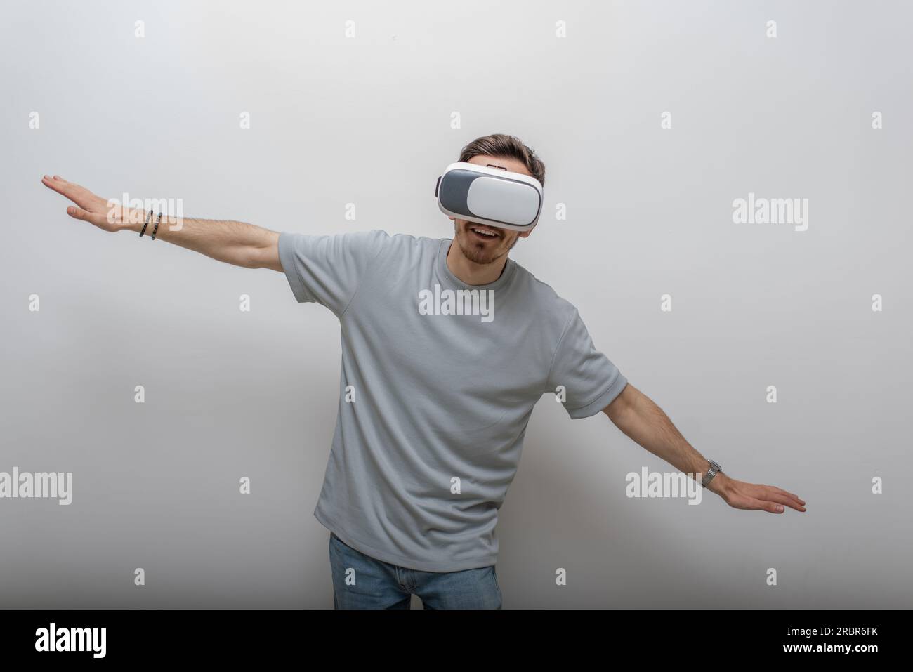 Futuristic man wearing virtual reality glasses interacts with the air ...