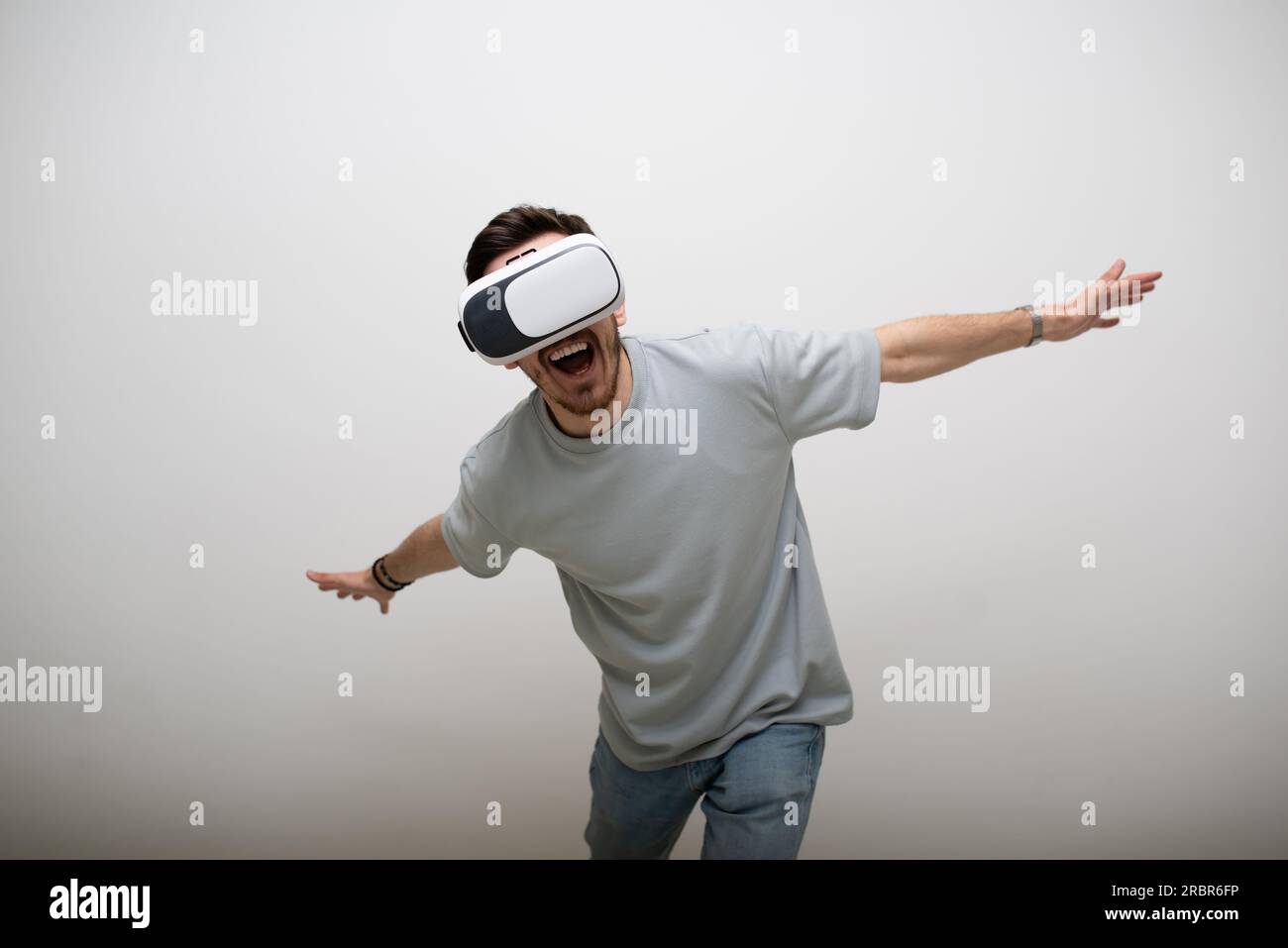 Futuristic man wearing virtual reality glasses interacts with the air ...