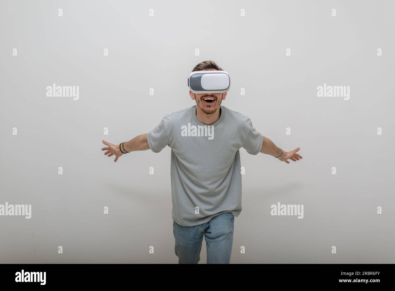 Futuristic man wearing virtual reality glasses interacts with the air ...