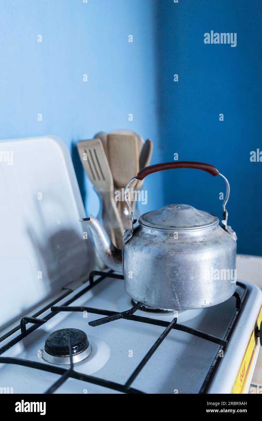 Premium Photo  Boiling water in ladle on blue flame burner steel pot on  gas burner