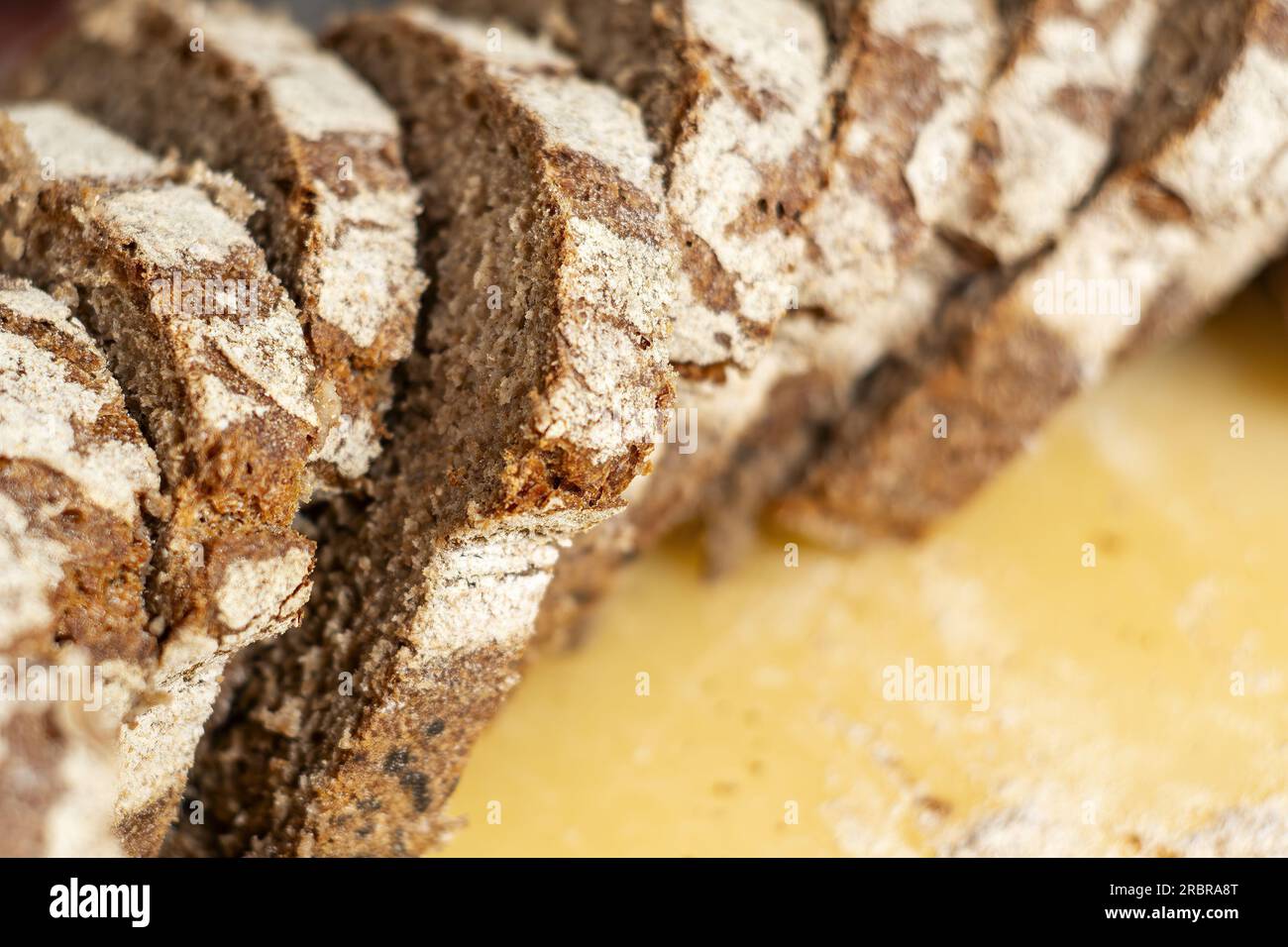 close-up view of some freshly cut slices of whole grain rye bread. Whole grain rye bread is made from all parts of the rye grain and has potential hea Stock Photo