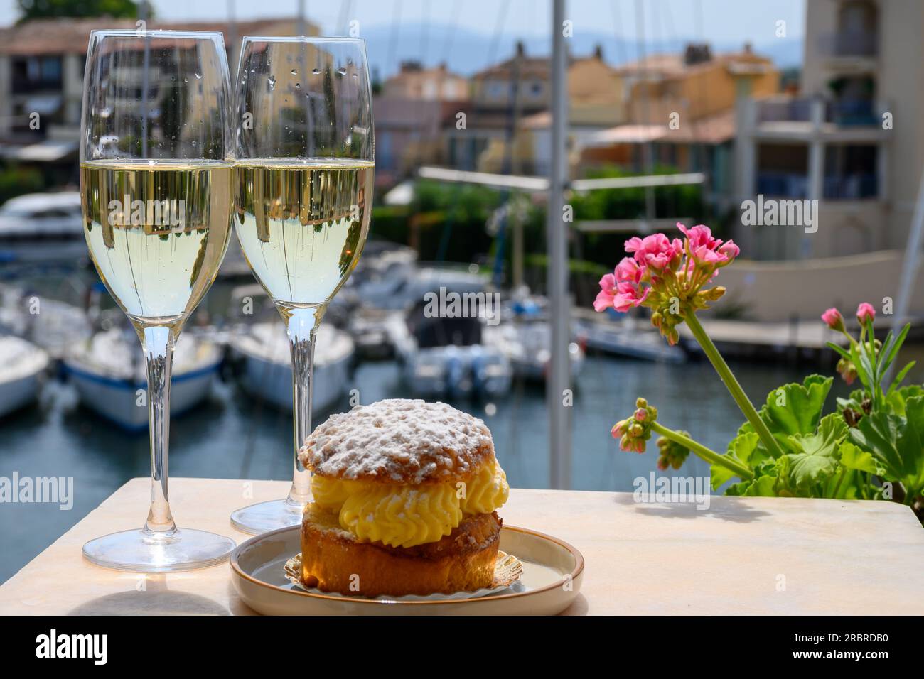 Drinking of French brut champagne sparkling wine with cake Tarte Tropezienne,  club party in yacht harbour of Port Grimaud near Saint-Tropez, French Ri  Stock Photo - Alamy