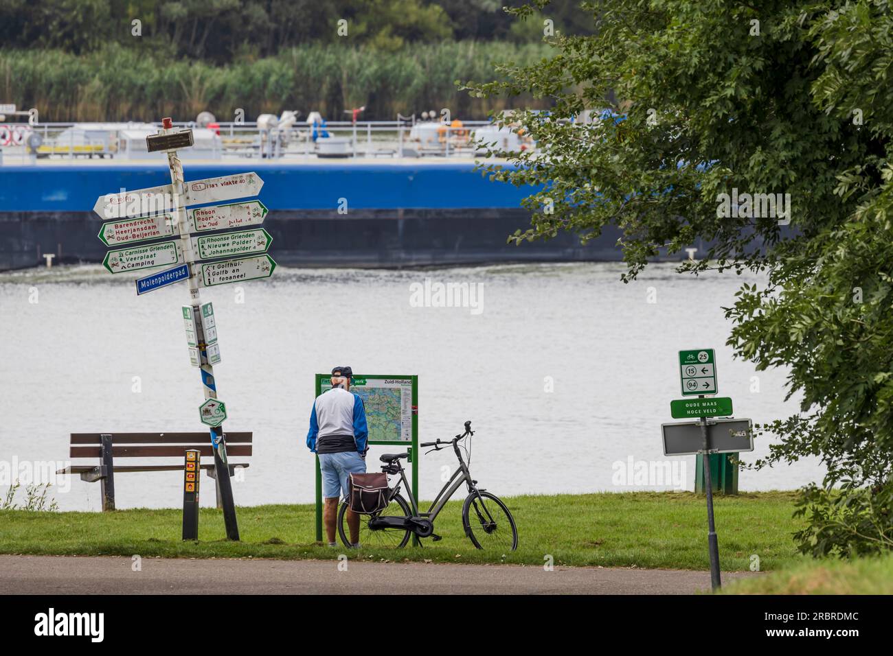 Barendrecht, the Netherlands - 2021-09-02: An elderly man checking the route for his cycling trip along the river Stock Photo