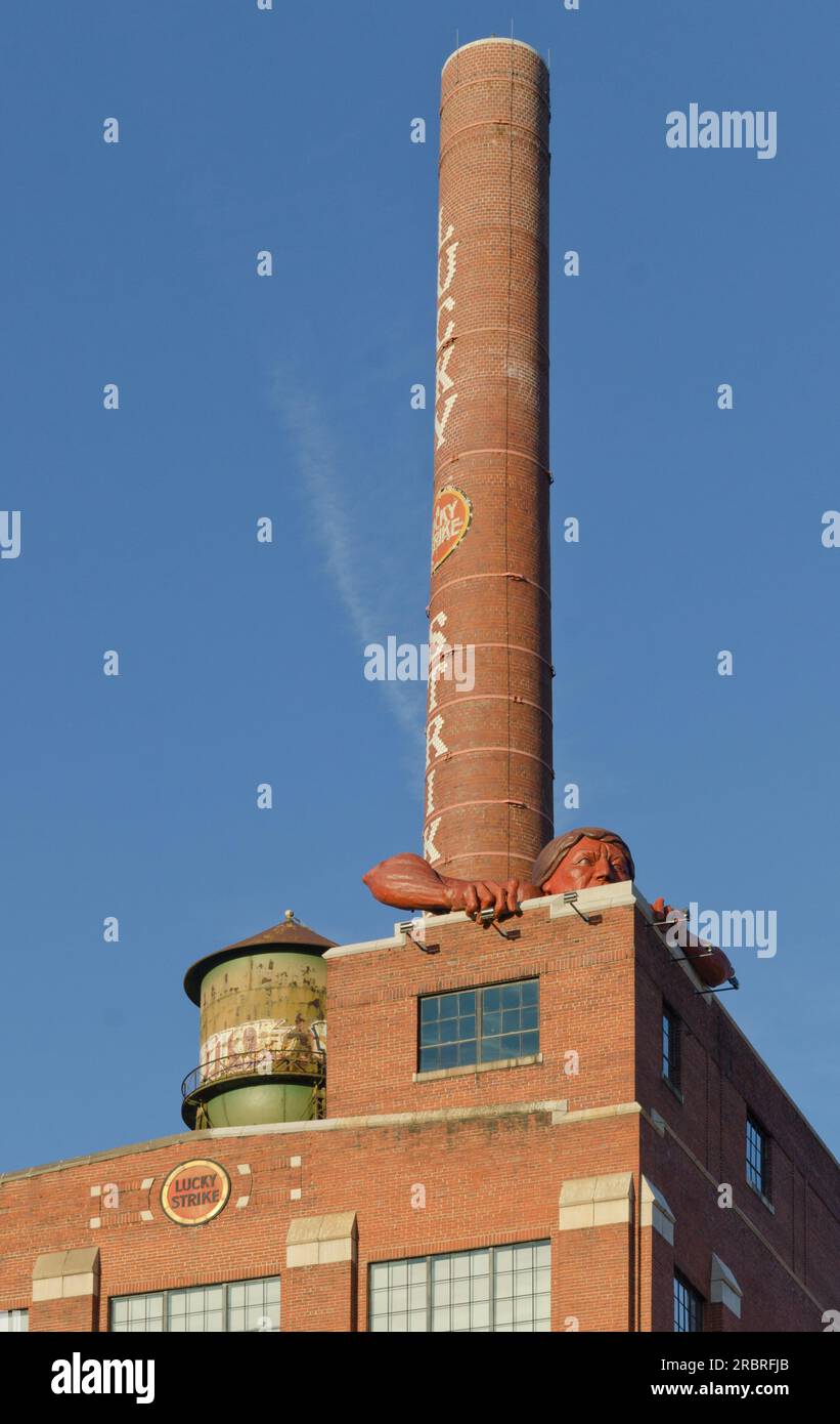 The Statue of 'Connecticut', a Native American Indian, lives atop the Lucky Strike cigarette factory overlooking the James River. Stock Photo