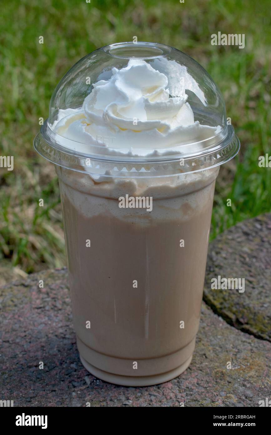 https://c8.alamy.com/comp/2RBRGAH/cool-down-with-a-cold-coffee-frappe-against-the-backdrop-of-natures-serene-beauty-2RBRGAH.jpg