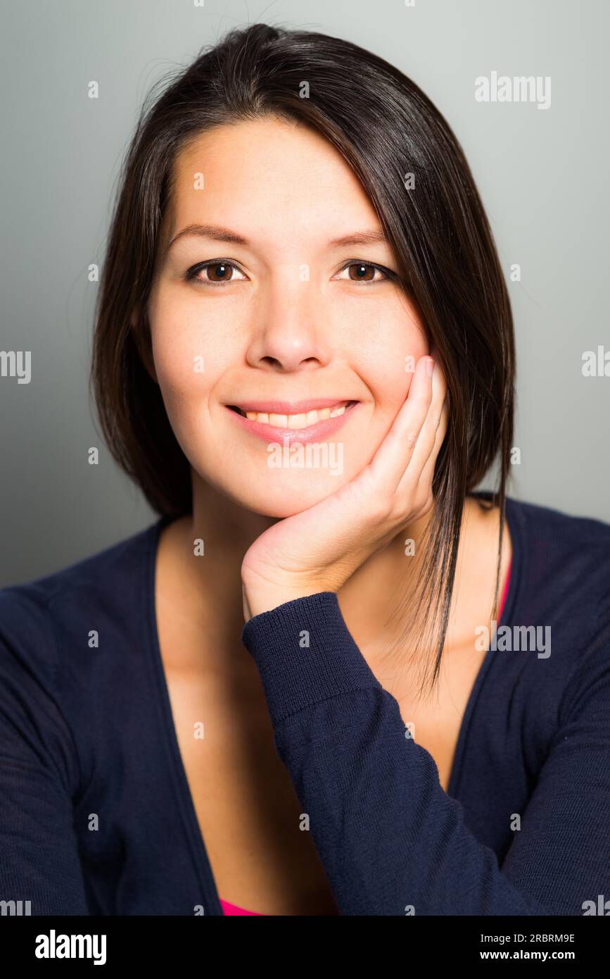 Beautiful young woman with a lovely warm smile resting her