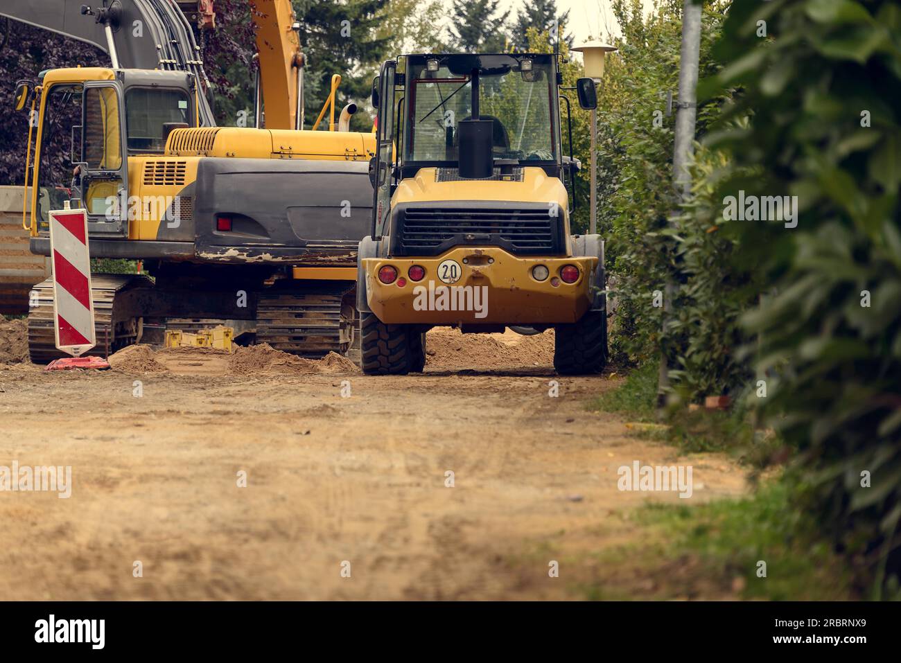 Variety of Construction Heavy Machinery Outdoors on Dirt Surface Stock Photo