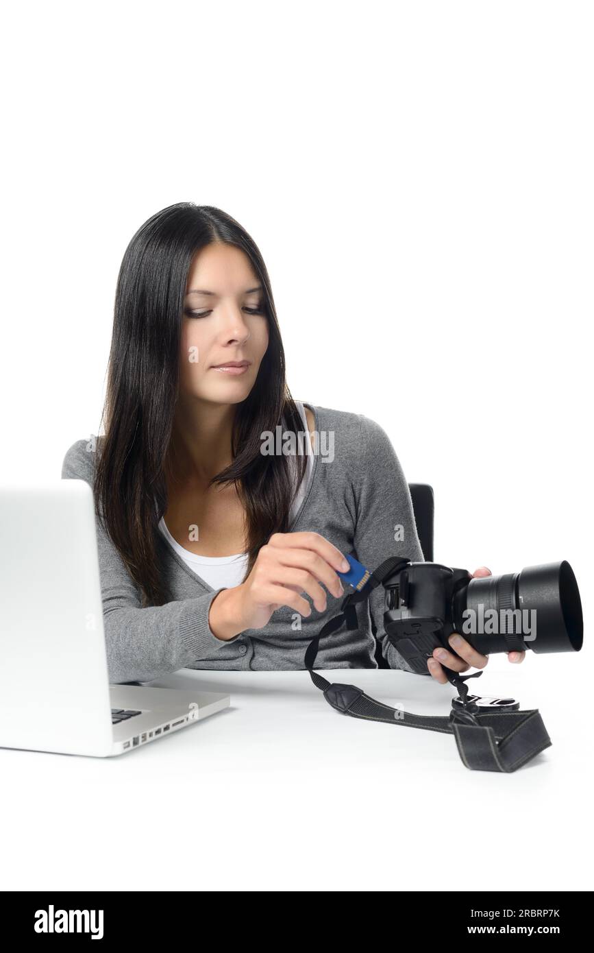Female photographer inserting or removing a memory card in her