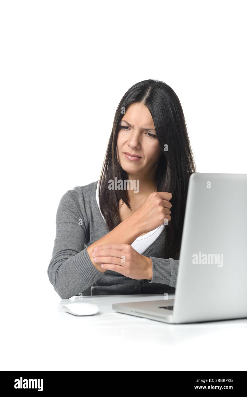 Young businesswoman rubbing and massaging her forearm to relieve cramps after using a computer mouse for too long at a stretch, on white Stock Photo