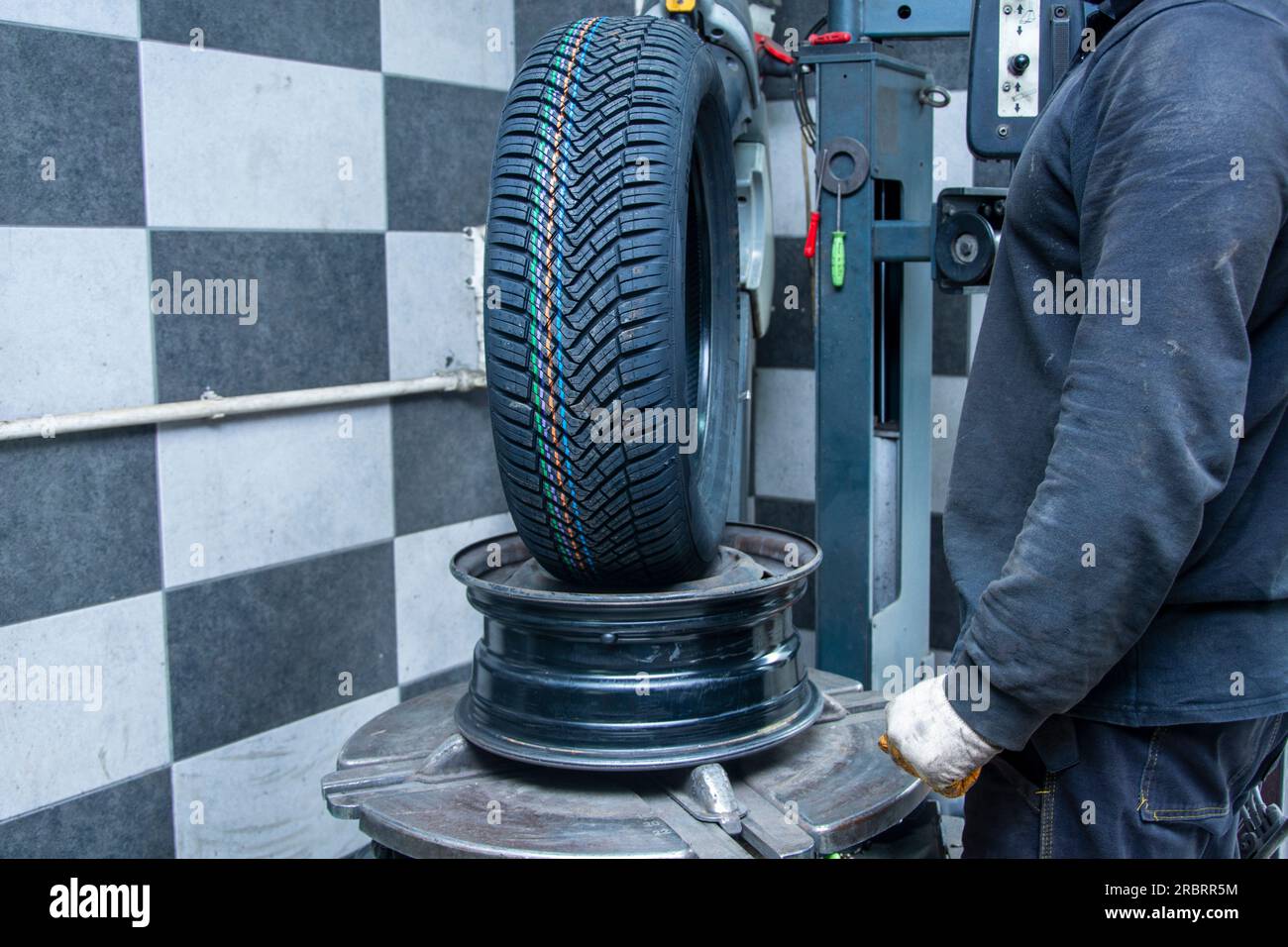 The service person prepares the rim before installing the new wheel Stock Photo